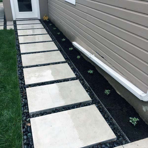 concrete steps with landscaping pebbles 