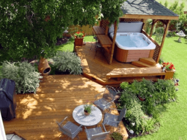 floating wood decks above ground hot tub pergola gray chairs and white table 