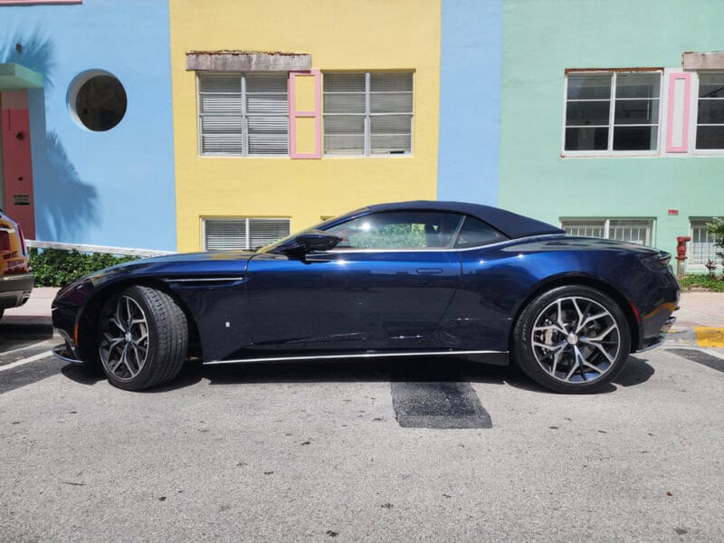 Dark blue convertible sports car parked on a Miami street, ideal for anyone wondering about Miami rental car prices