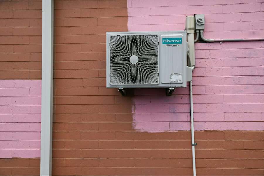 Hisense air conditioner mounted on a brick wall, suitable for HVAC pros inspecting mini-split leaks or indoor water issues