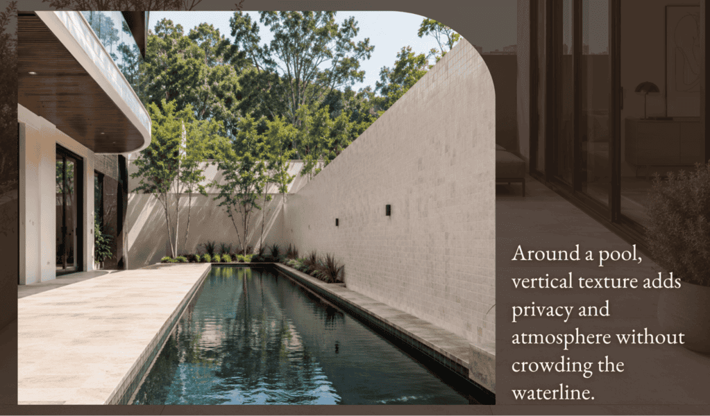 A modern narrow pool bordered by tall textured walls and trees, with sleek outdoor tiles for a private, tranquil backyard retreat