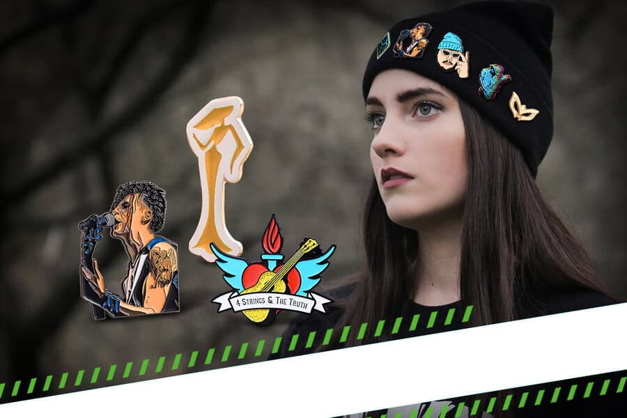 Woman in a black beanie with custom pins; graphic singer, fist, and heart with guitar pins shown beside her