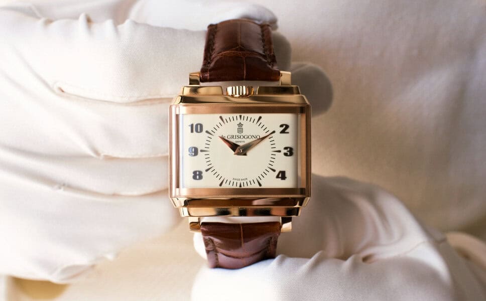 A gloved hand holds a gold square wristwatch, highlighting its value for any vintage watch collection