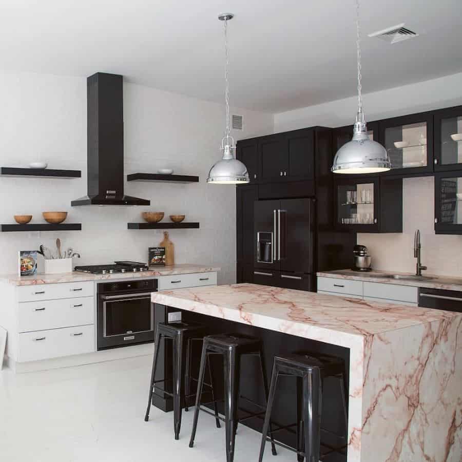 silver pendant industrial lighting in modern kitchen with marble countertops