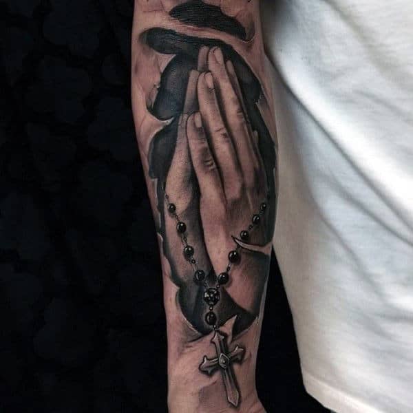 Inner Forearm Ripped Skin Cross And Praying Hands Tattoo For Men