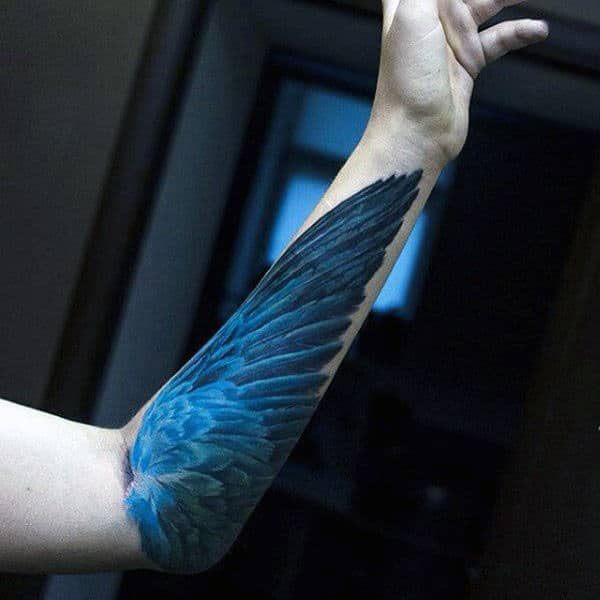 Insane Guys Angel Wings Tattoo On Forearm With Blue Ink