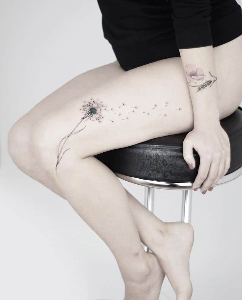 intricate dandelion tattoo on leg