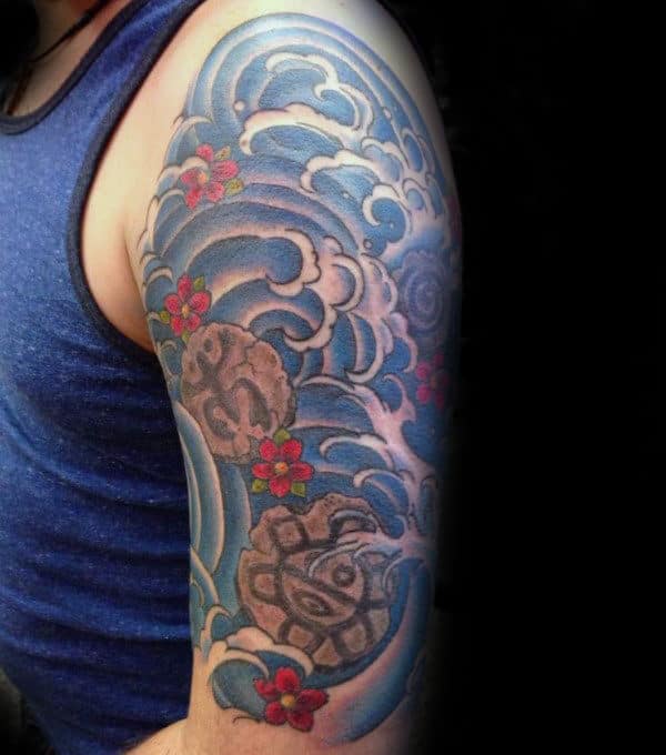 Japanese Ocean Waves With Taino Carved Rocks Tattoo For Men