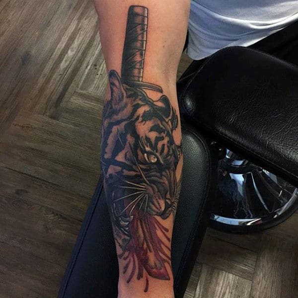 Katana tattoo on the right forearm