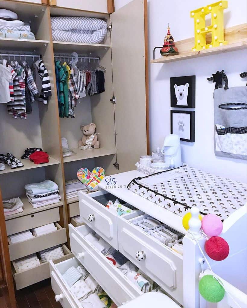 Organized kids' room with closet storage, dresser drawers, and changing table.