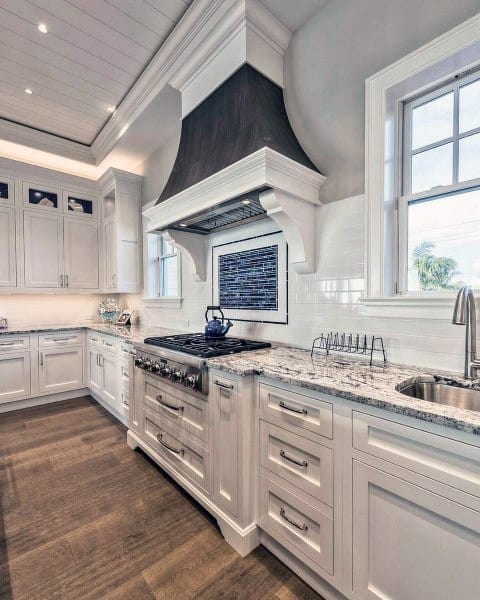 country kitchen with white cabinets and tile splashback 