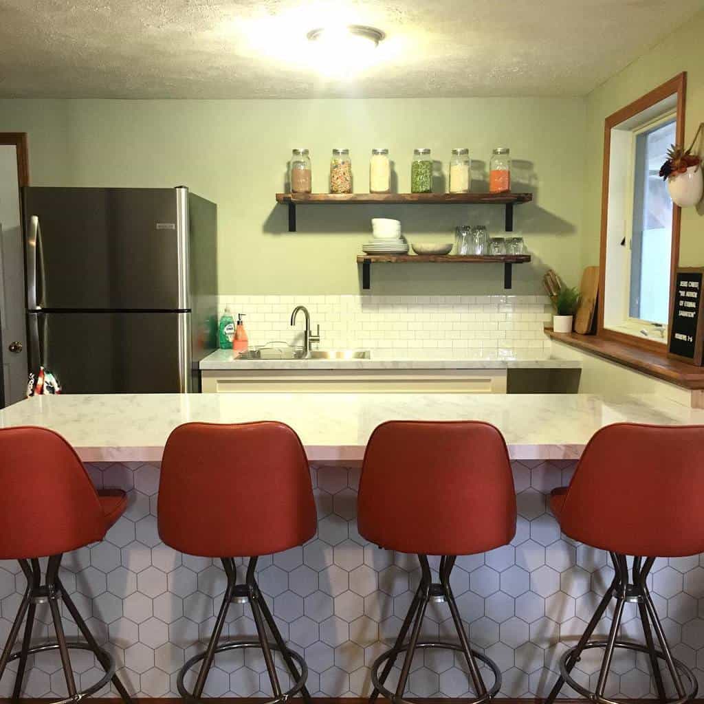 green vintage kitchen with white tile backsplash 