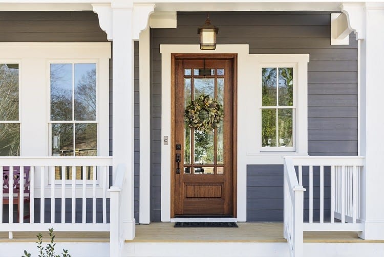 large craftsman exterior white window trim front porch wood door