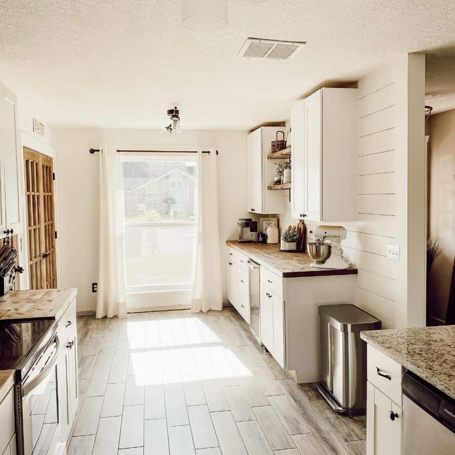 rustic country kitchen shiplap walls white cabinets curtains 