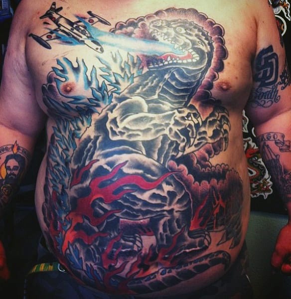 Large Stomach Tattoo Of Godzilla In Water And Plane On Man