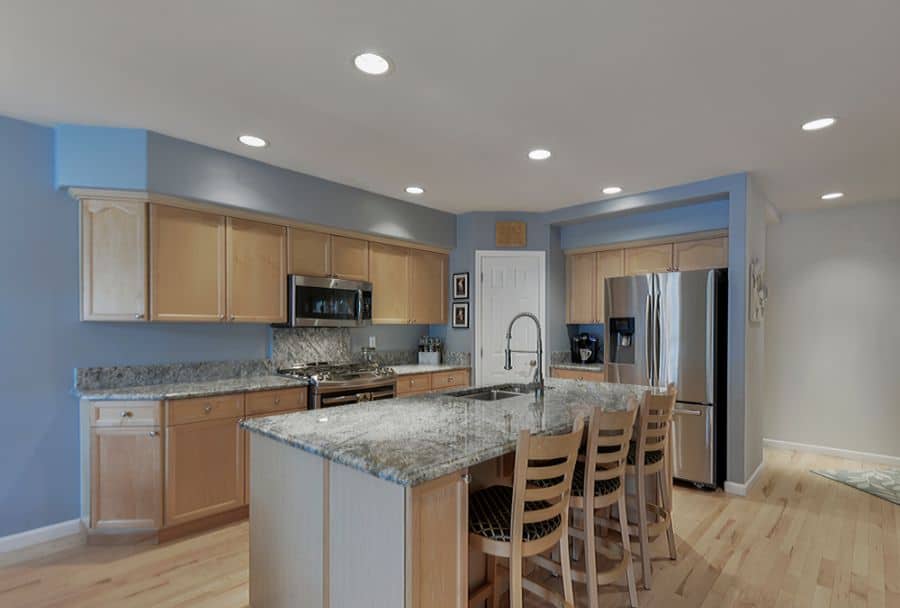 wood cabinet kitchen granite countertop gray wall