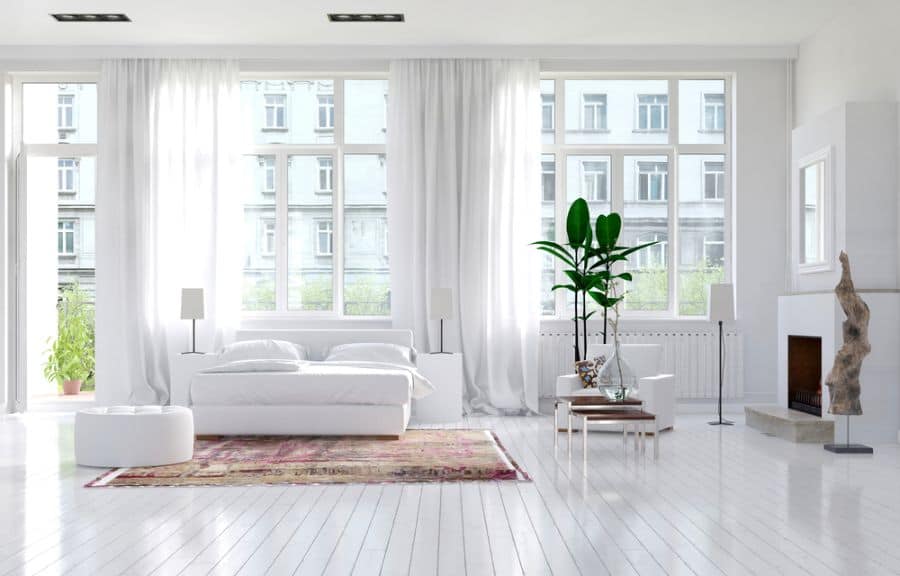 new york style loft apartment bedroom white flooring large windows fireplace