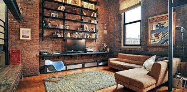 brick wall living room with wall shelves and sofa 
