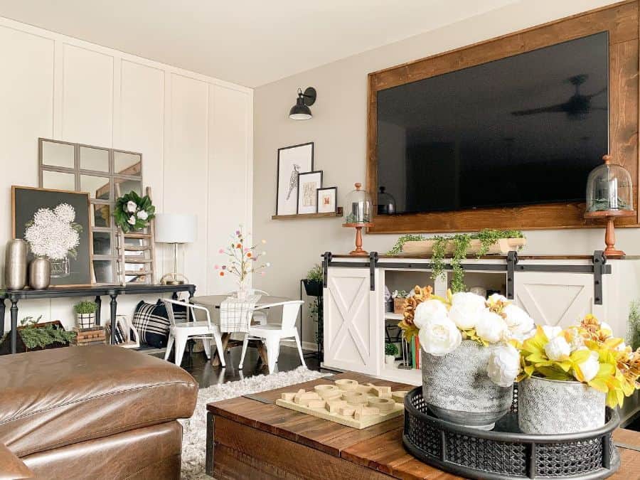 rustic living room with large wall mounted tv and vintage decor 