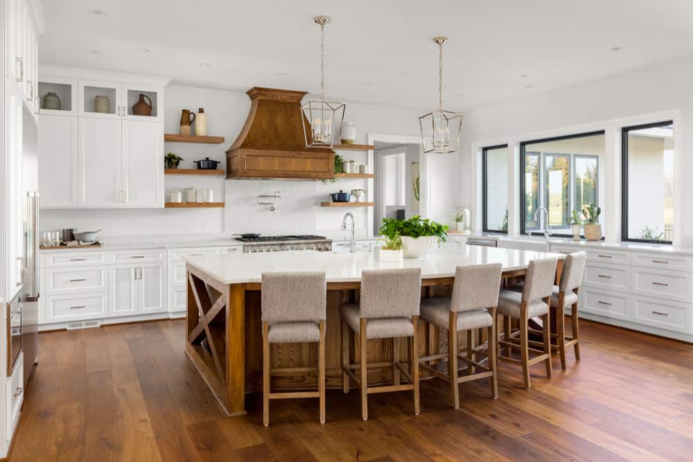 large luxury farmhouse kitchen hardwood floors wood island marble countertop pendant lights