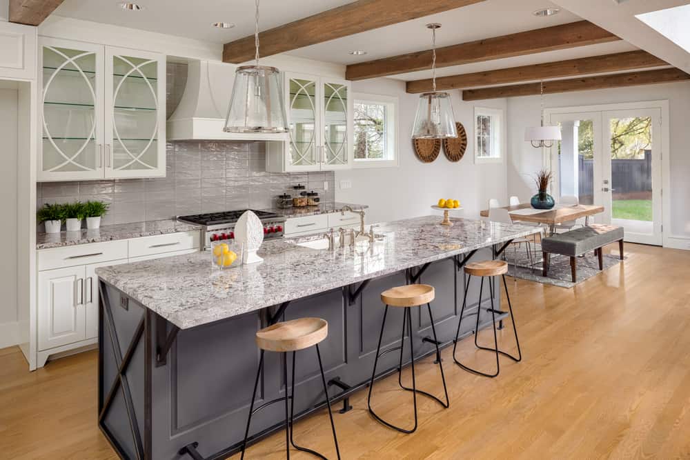 luxury farmhouse kitchen long gray island marble topped gray tile splashback