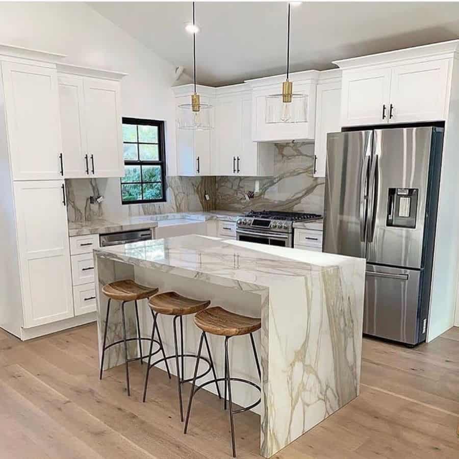 luxury farmhouse kitchen marble island wood stools white cabinets wood flooring 