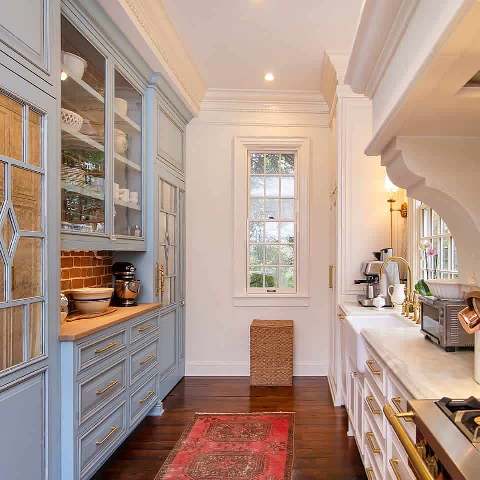 luxury country galley kitchen blue and white cabinets gold accents wicker basket