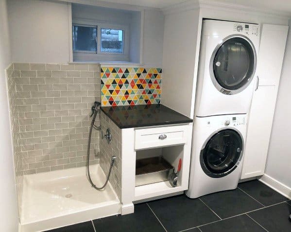 laundry room washing machine dryer small dog shower gray tiles white cabinets 