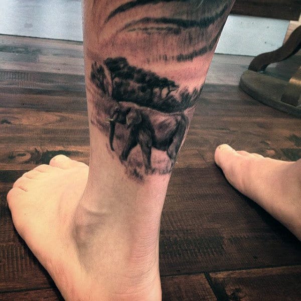 Male Ankles Elephant In A Field Tattoo