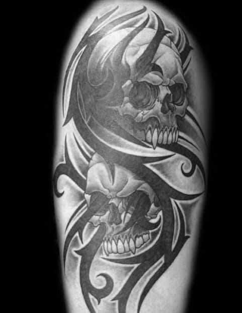 Male Arm Tattoo With Tribal Skull Design