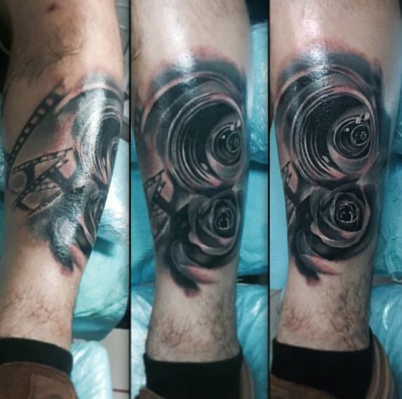 Male Calves Rose And Lens Tattoo