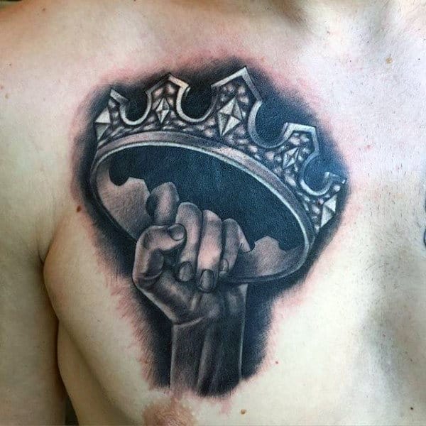 Male Chest Hand Holding Crown Tattoo