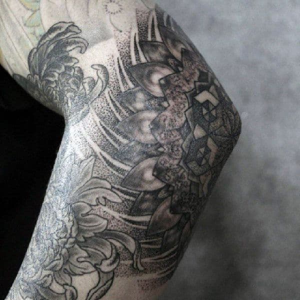 Male Elbow Tattoo With Floral Theme And Shapes