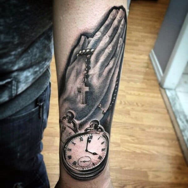 Male Praying Hands Cross Tattoo With Clock On Outer Forearm