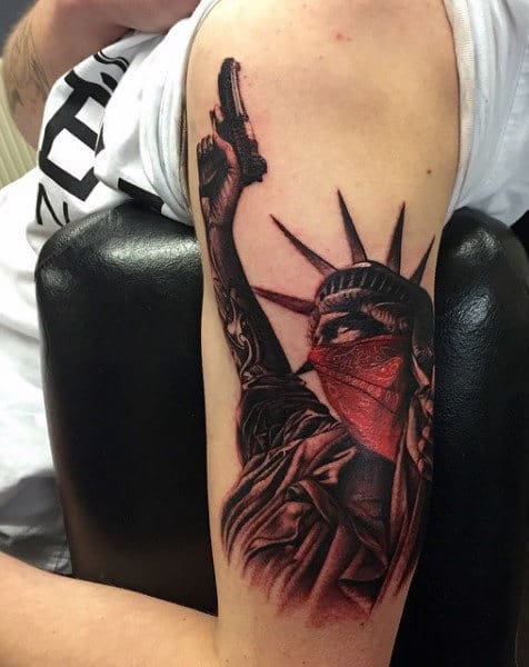 Hand poked statue of liberty tattoo ln the upper arm