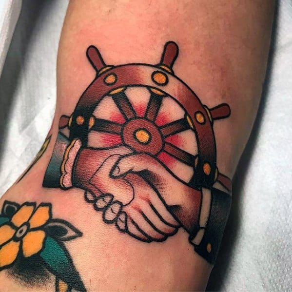 Male Tattoo With Ship Wheel Handshake Design On Ditch Elbow Crease
