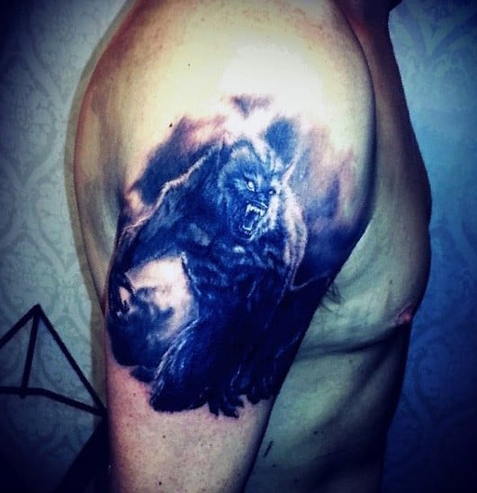 Male With Blue Black Shaded Werewolf Tattoo On Upperarms