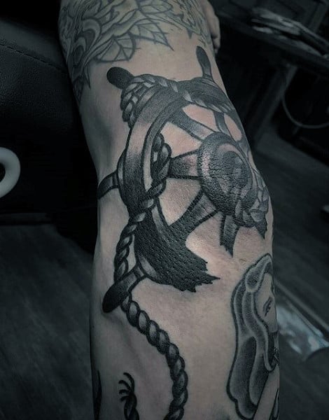 Male With Broken Ship Wheel Rope Nautical Elbow Tattoo