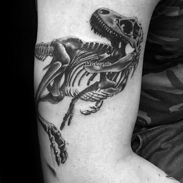 Male With Cool Jurassic Park Dinosaur Skeleton Bones Arm Tattoo Design