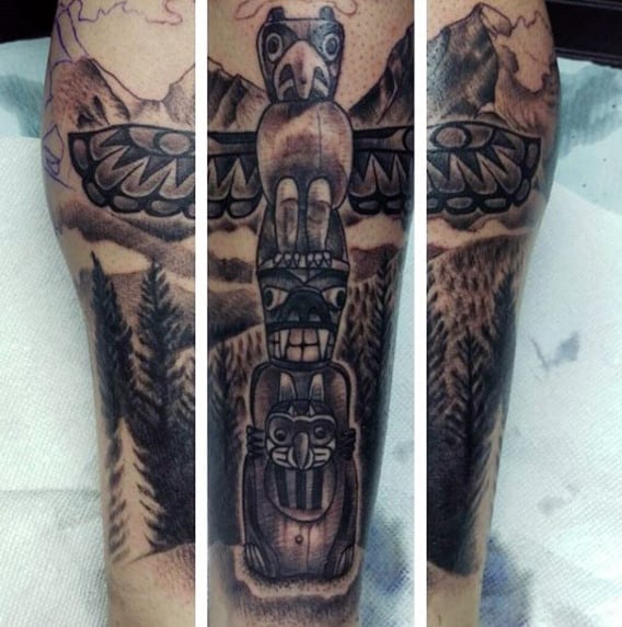 Male With Eagle And Demon Totem Pole And Mountainscape Calf Tattoo