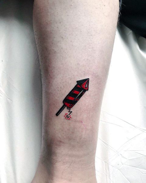 Male With Fireworks Tattoos On Lower Leg