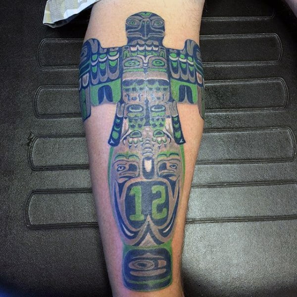 Male With Green And Black Stylist Totem Pole Calf Tattoo