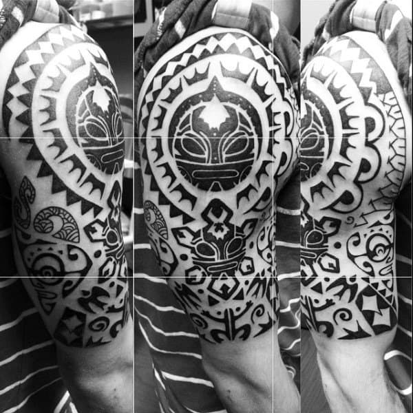 Male With Half Sleeve Taino Tribal Sun And Frog Themed Tattoos