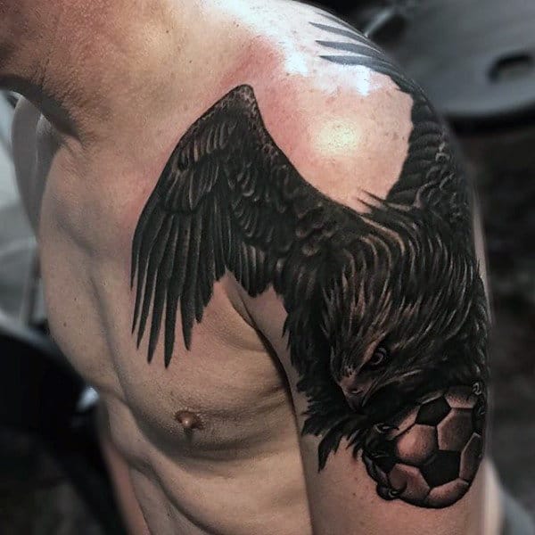 Male With Hawk Soccerball Tattoo On Arm And Chest