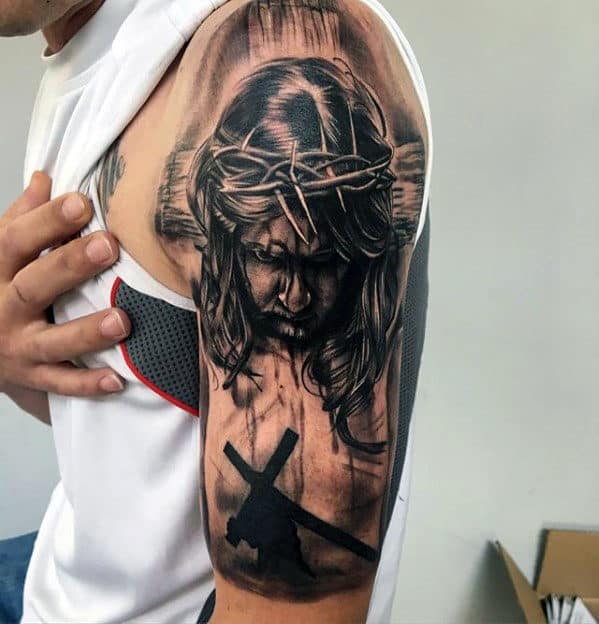 Male With Jesus Walking With Cross Arm Tattoo