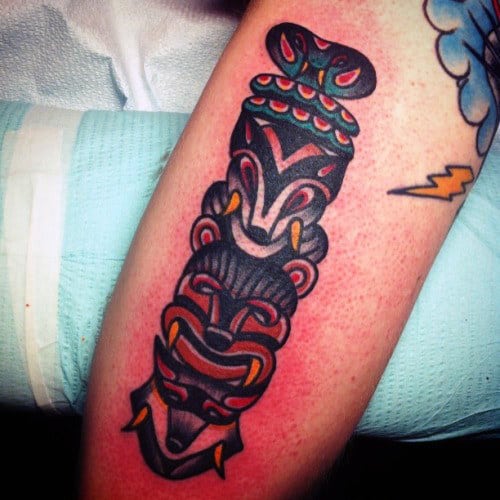 Male With Neo Traditional Cartoonish Totem Pole Forearm Tattoo