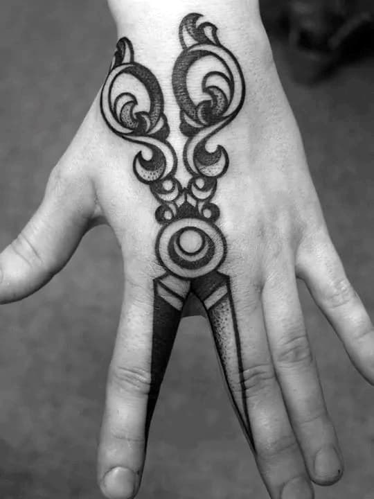 Scissor outline tattoo on the right wrist