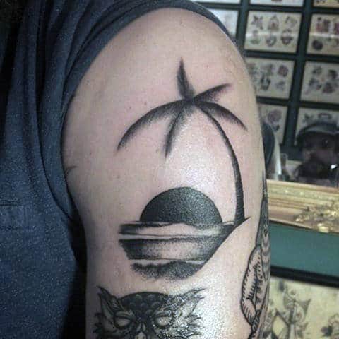 Male With Palm Tree And Beach Tattoo On Upper Arms