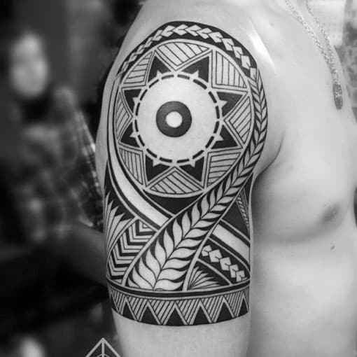 Male With Polynesian Tribal Sun Half Sleeve Tattoo On Arm