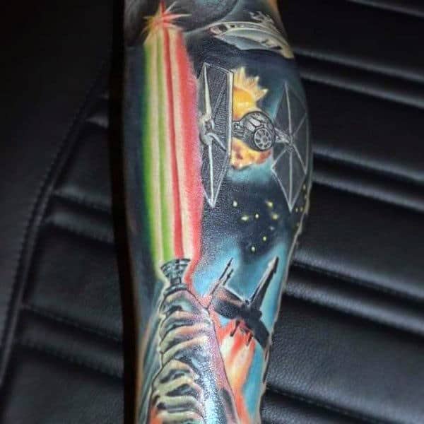 Male With Sleeve Tattoo Of Lightsaber And Spaceships
